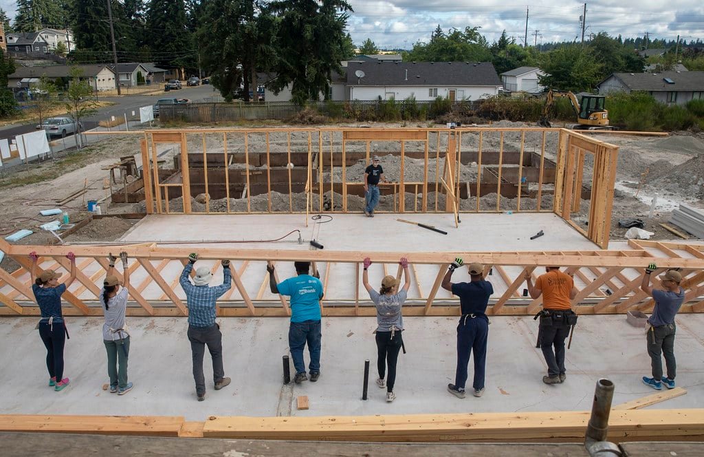 Volunteers raising wall frames at a Golden Crescent Habitat for Humanity home build in Victoria TX