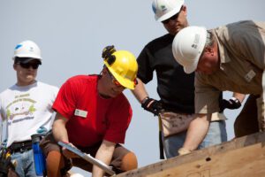 Habitat for Humanity volunteers participating in a veteran-focused home repair project