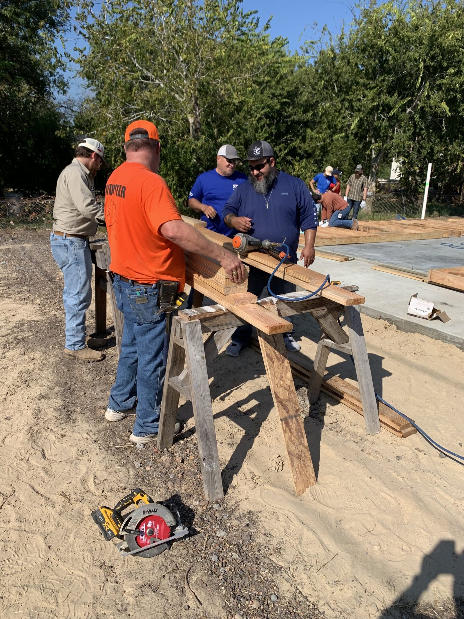 Golden Crescent Habitat for Humanity volunteers cutting lumber at a new home construction site